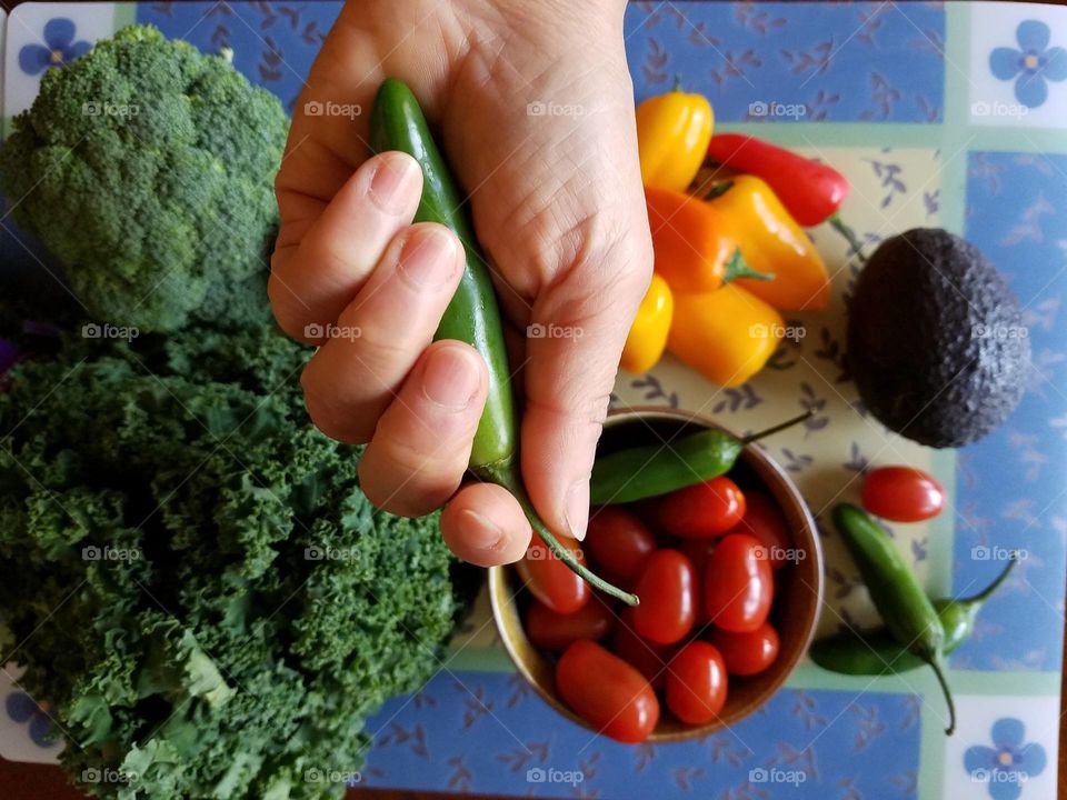 Holding Serrano chilli