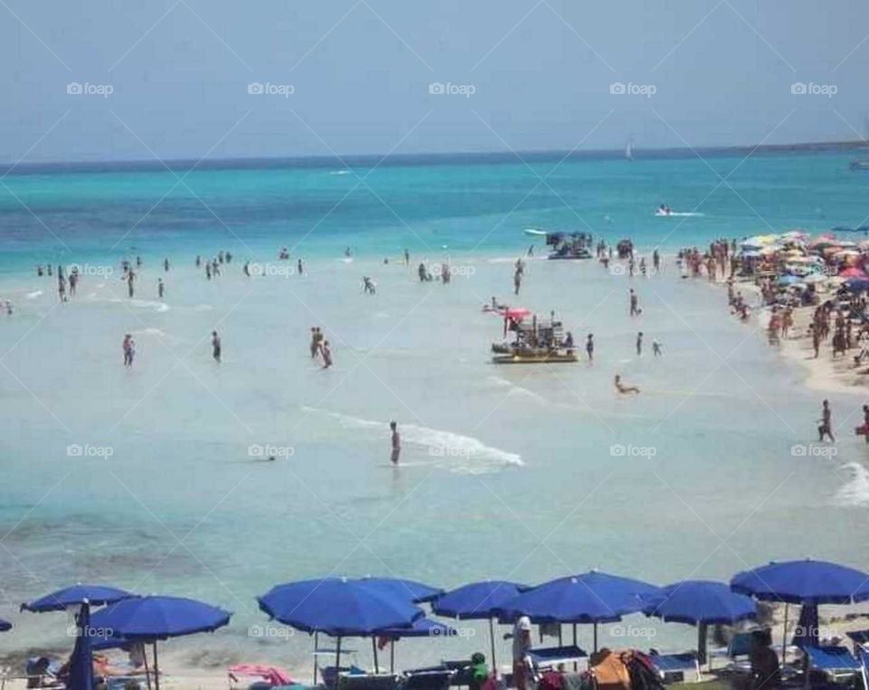 Beach#sea#humans#parasols