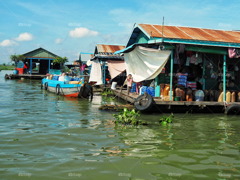 Little boy in floating village on Tonle Sap river, Cambodia 