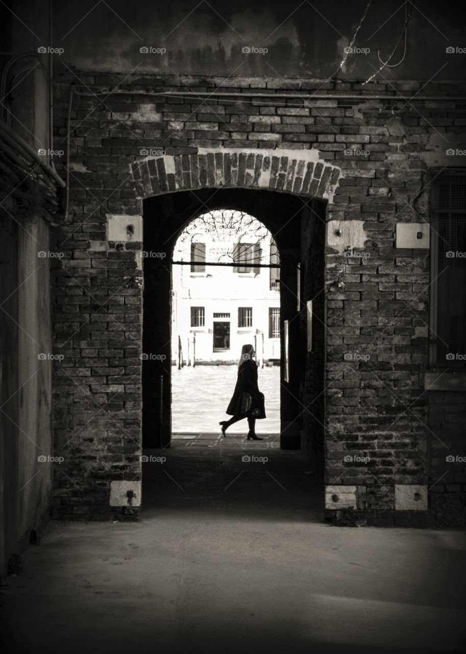 A woman walking in Italy.