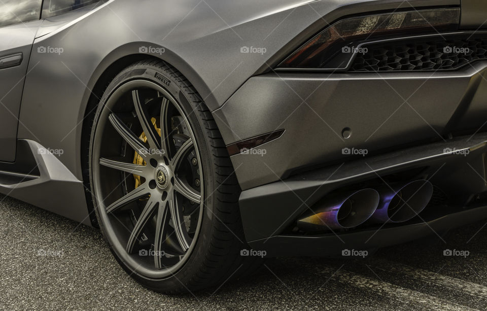 Rear side view of tail light, exhaust and whee/tire of Lamborghini 