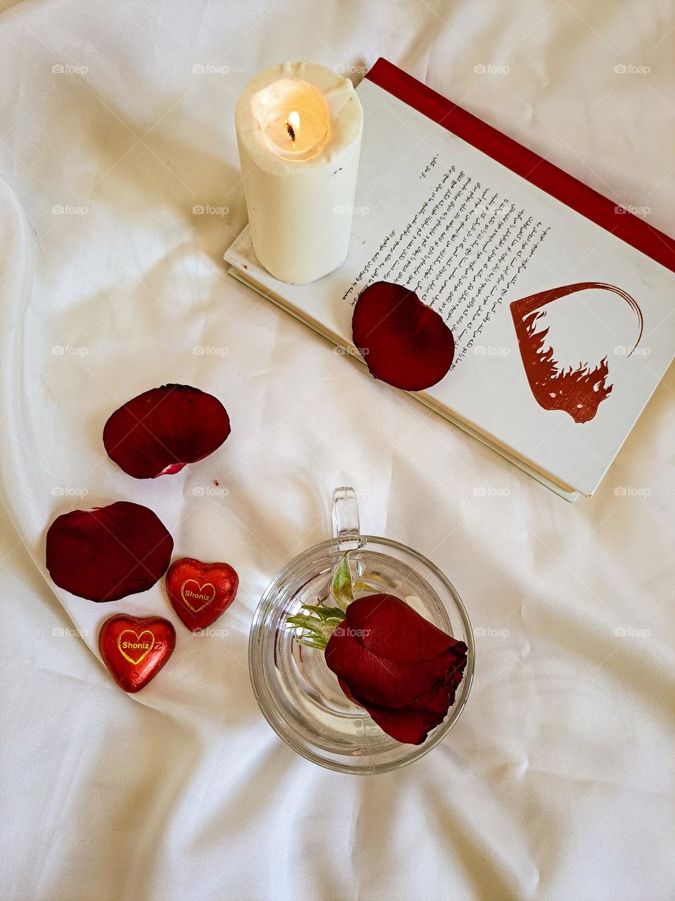 A rose in a cup of water with a book🌹😍