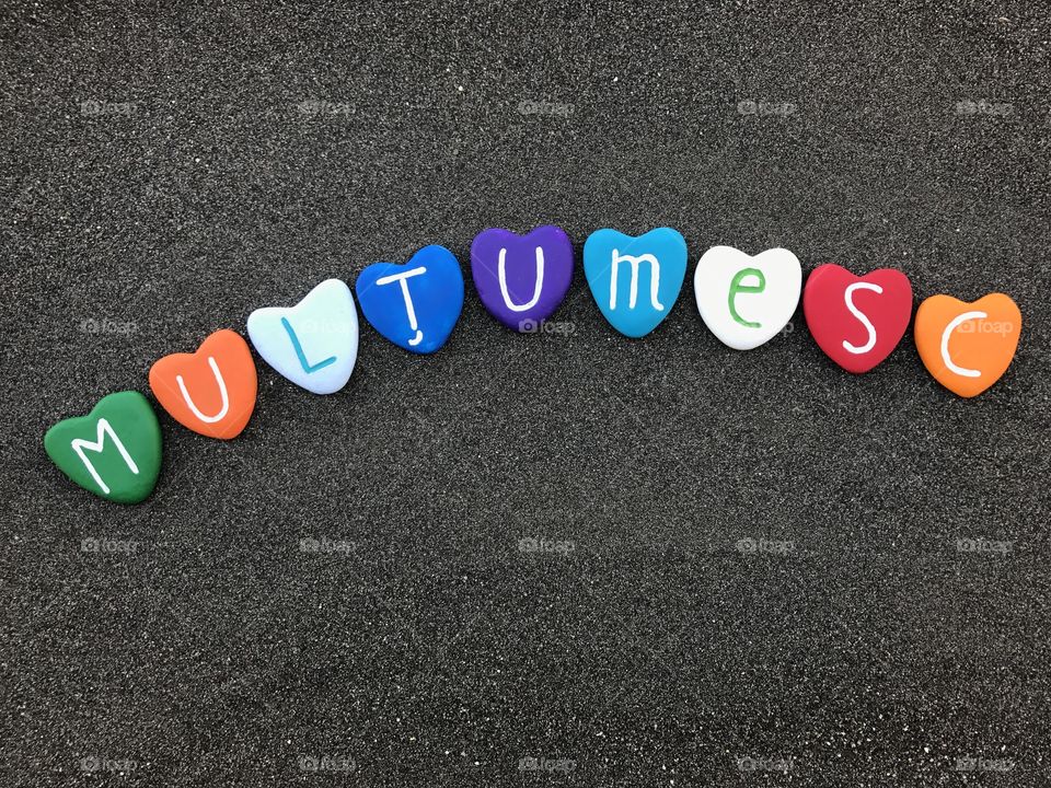 Mulţumesc, romanian thank you with colored heart stones over black volcanic sand


