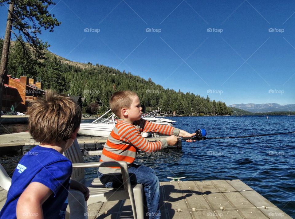 Young Brothers Fishing In A Mountain Lake
