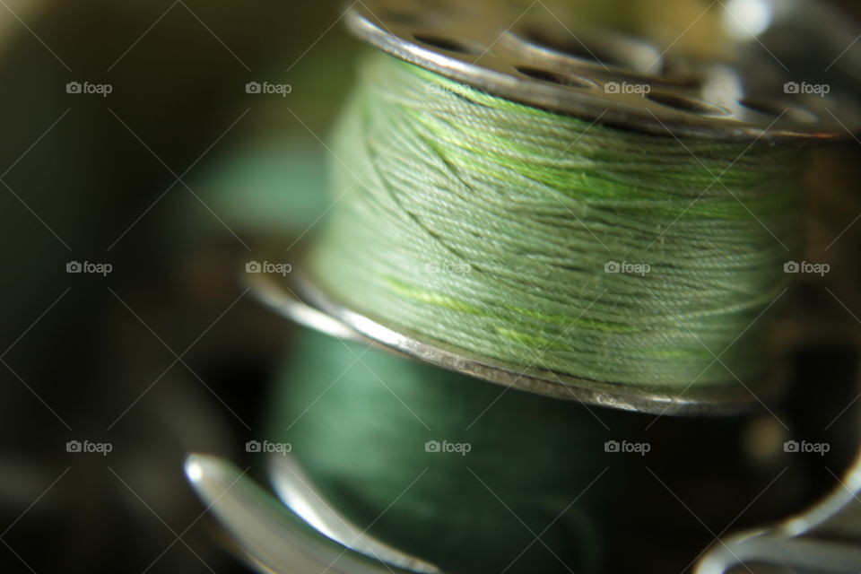 Light green & green stacked metal thread bobbins