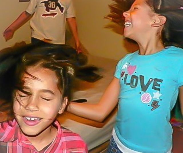 Happiness. Kids jumping on the bed