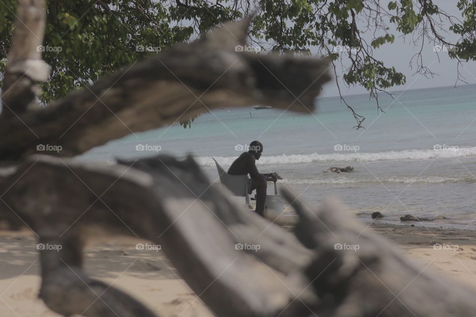 Man hanging by the beach