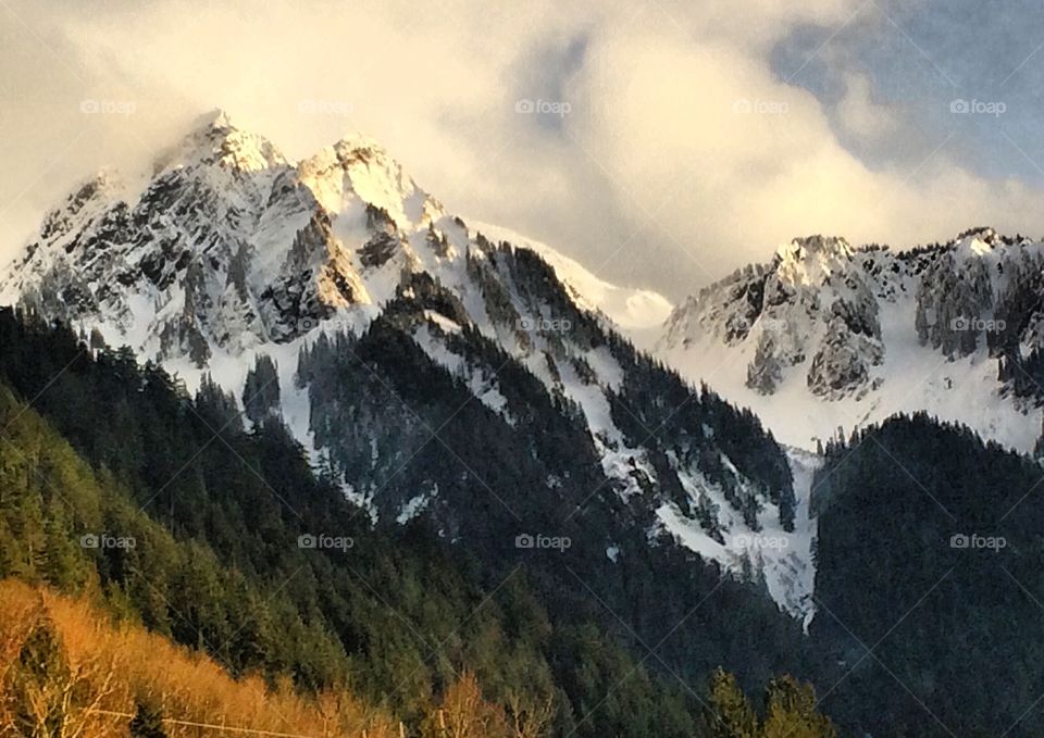 Evening light on the snow covered mountain peaks.