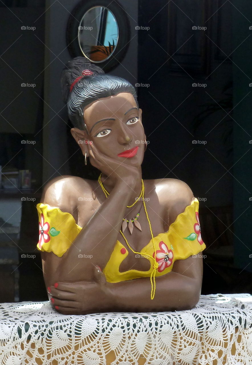 Wooden woman at window in Salvador de bahia