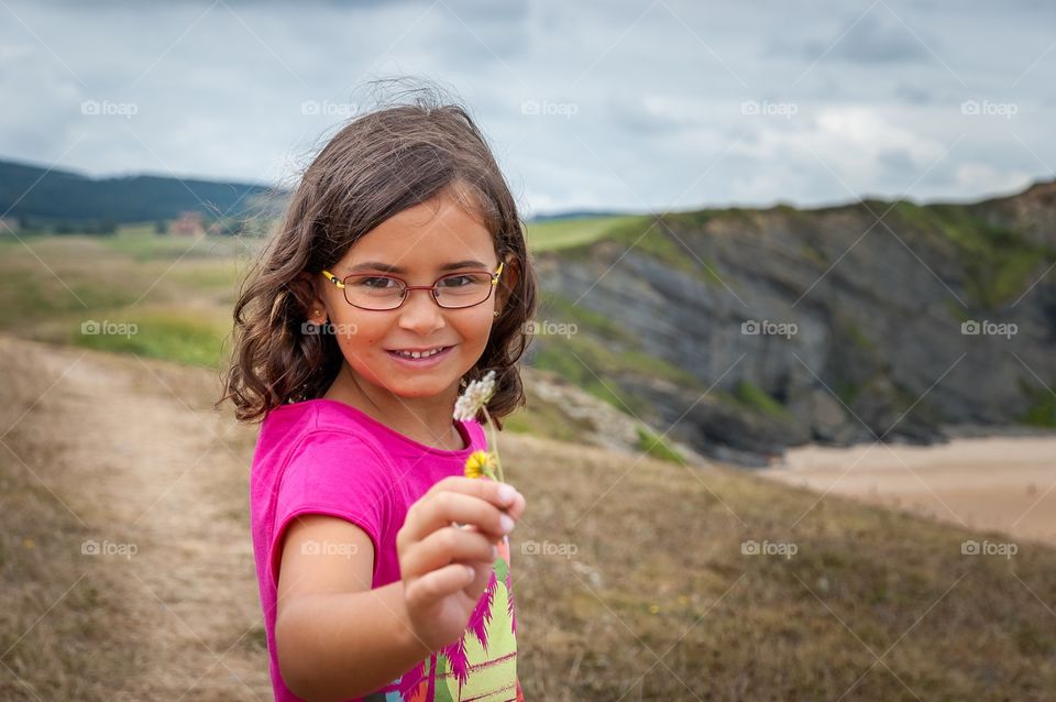 Girl offering a flower 