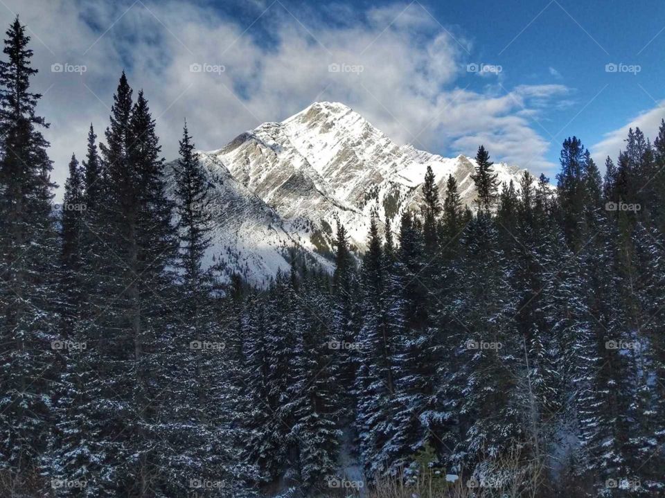 Sun shining on snow covered Mountains