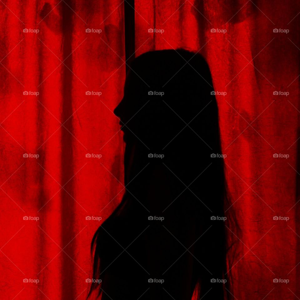 young girl on red background, long straight hair