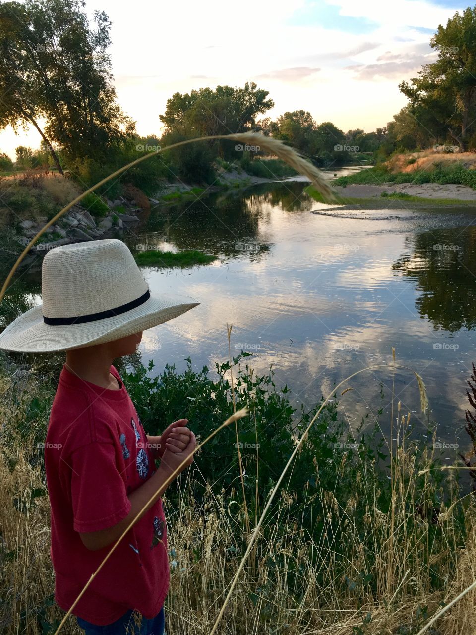 Summer nights. Boy. Hat. River. Relaxing. Reflection. Beautiful 