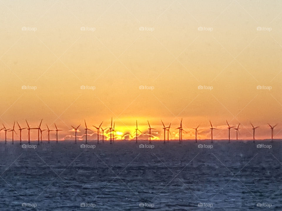 Sunset with a sea wind farm