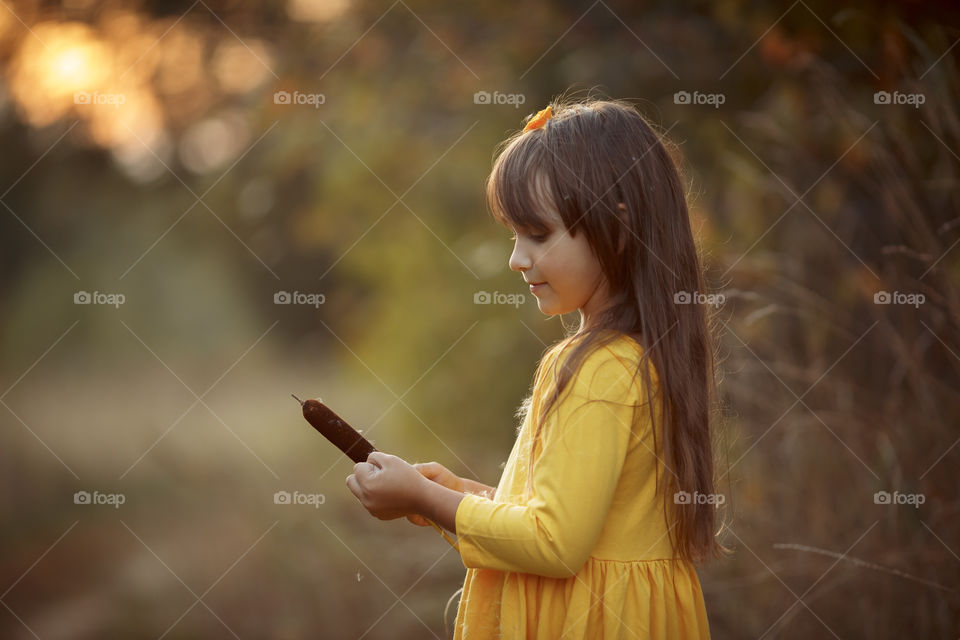 Little girl in yellow dress outdoor portrait 