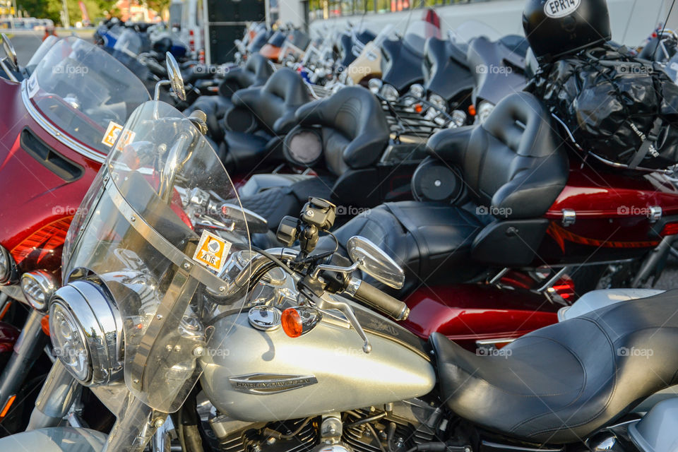 a large collection of motorcycles parked outside a hotel in Denmark.