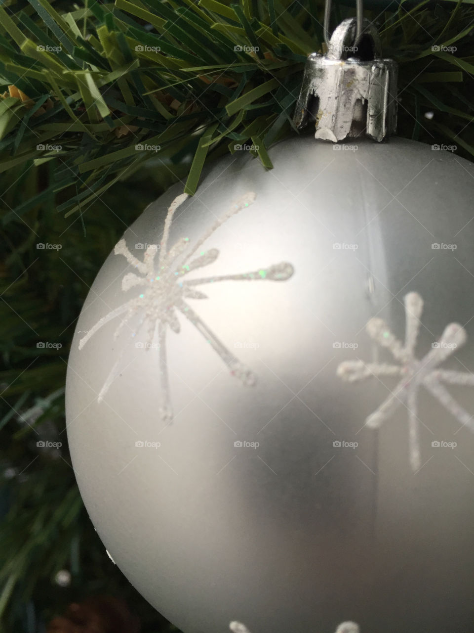 Grey baubles hang happily from the tree