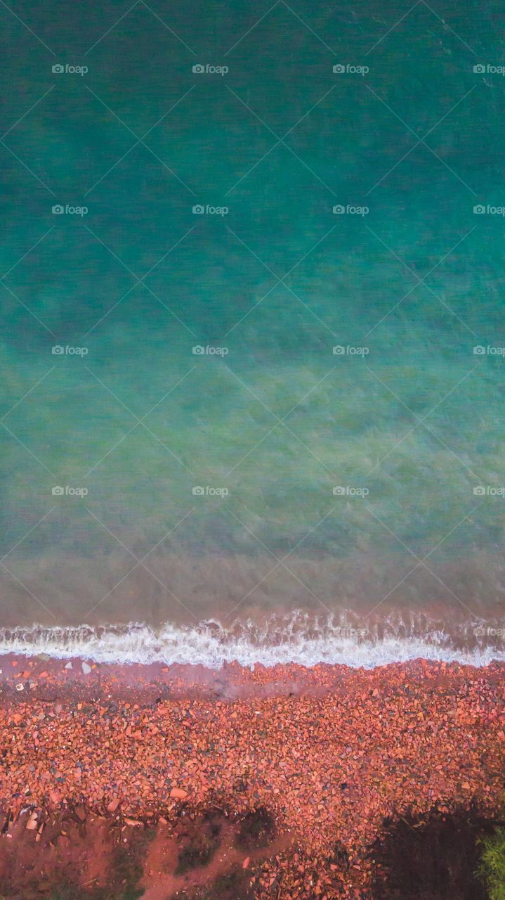 beach with red and blue stone