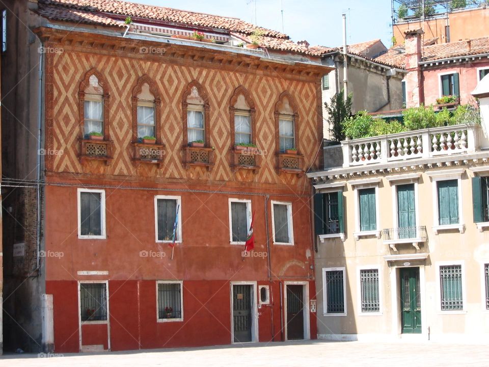 Venetian buildings with patterned decoration, roof gardens and shuttered windows 