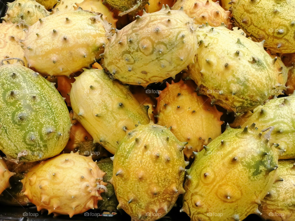 Bulk kiwano melons in a grocery store