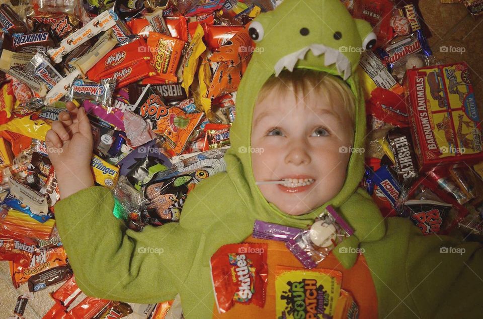 Boy lying on sweet candies