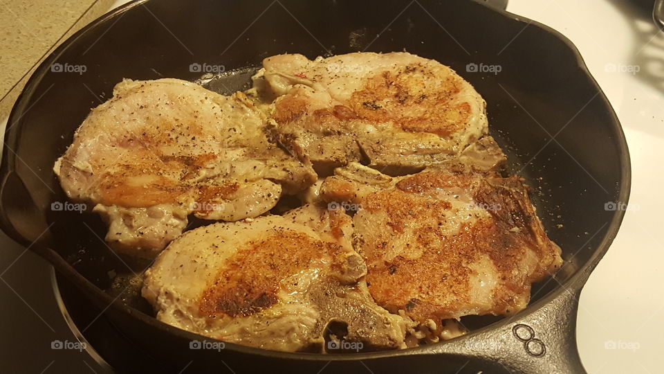 four pork chops cooking