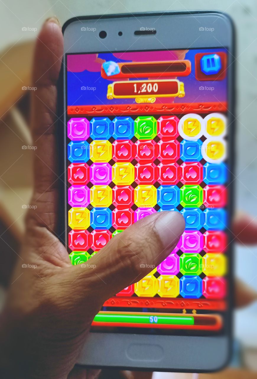 My Secret Ritual - Playing match game on mobile  phone.