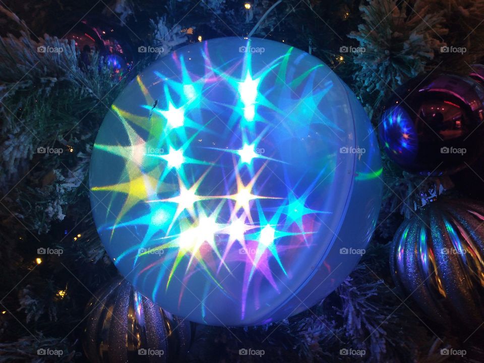 A light ball beside the Christmas tree.