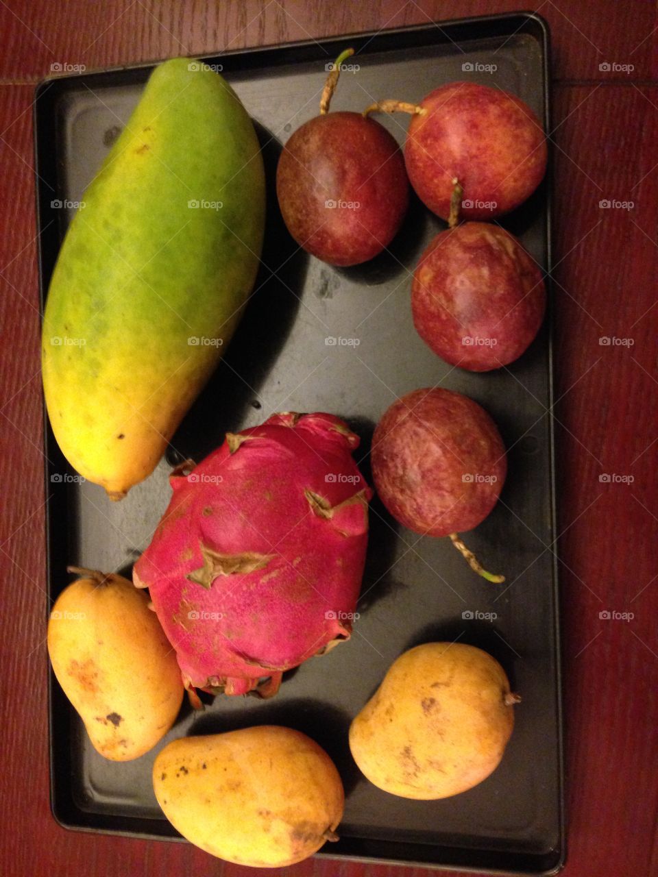 A selection of tropical fruits: mangos, dragon fruit, passion fruit. Bought on a evening market in south China.
