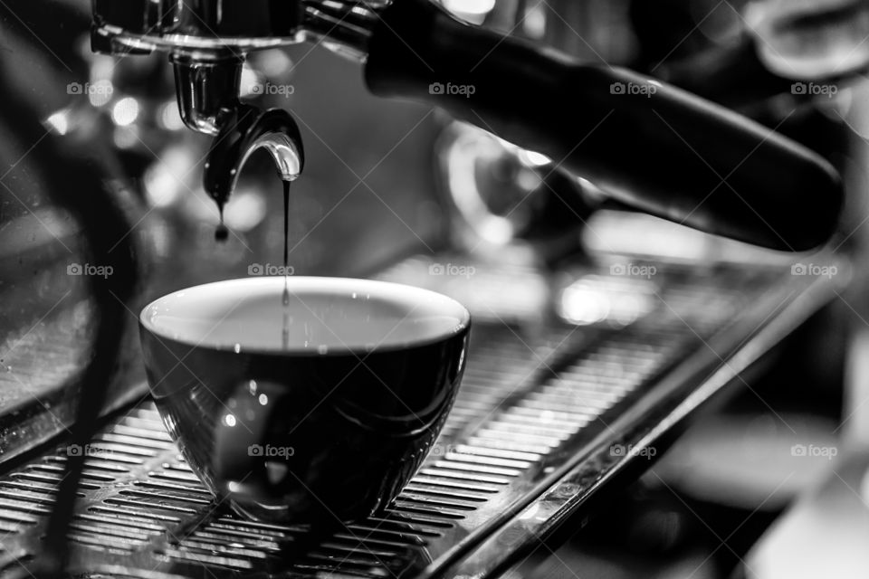 Cappuccino in making, process at the coffee machine