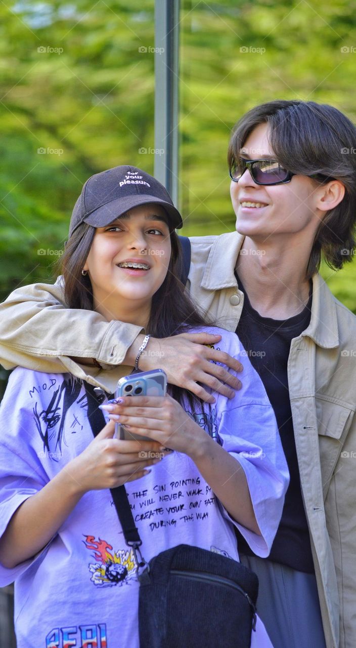 young couple of lovers hugging on a walk in the city