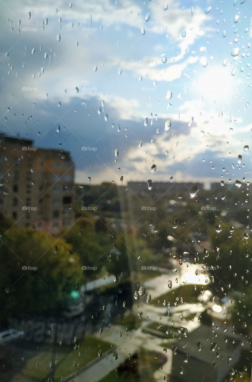 The rain with the sun through the window