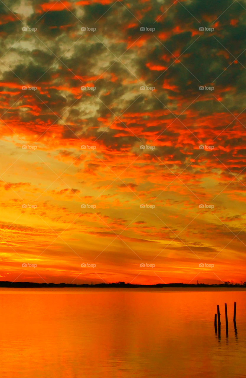 Incredible Sunsets! I am a Sunset enthusiast! The brilliant crimson, amber,tangerine, and blue hues of the sunsets sweep the sky and the surface of the waterways as the beautiful colors embrace the heavenly sky! Breathtaking!