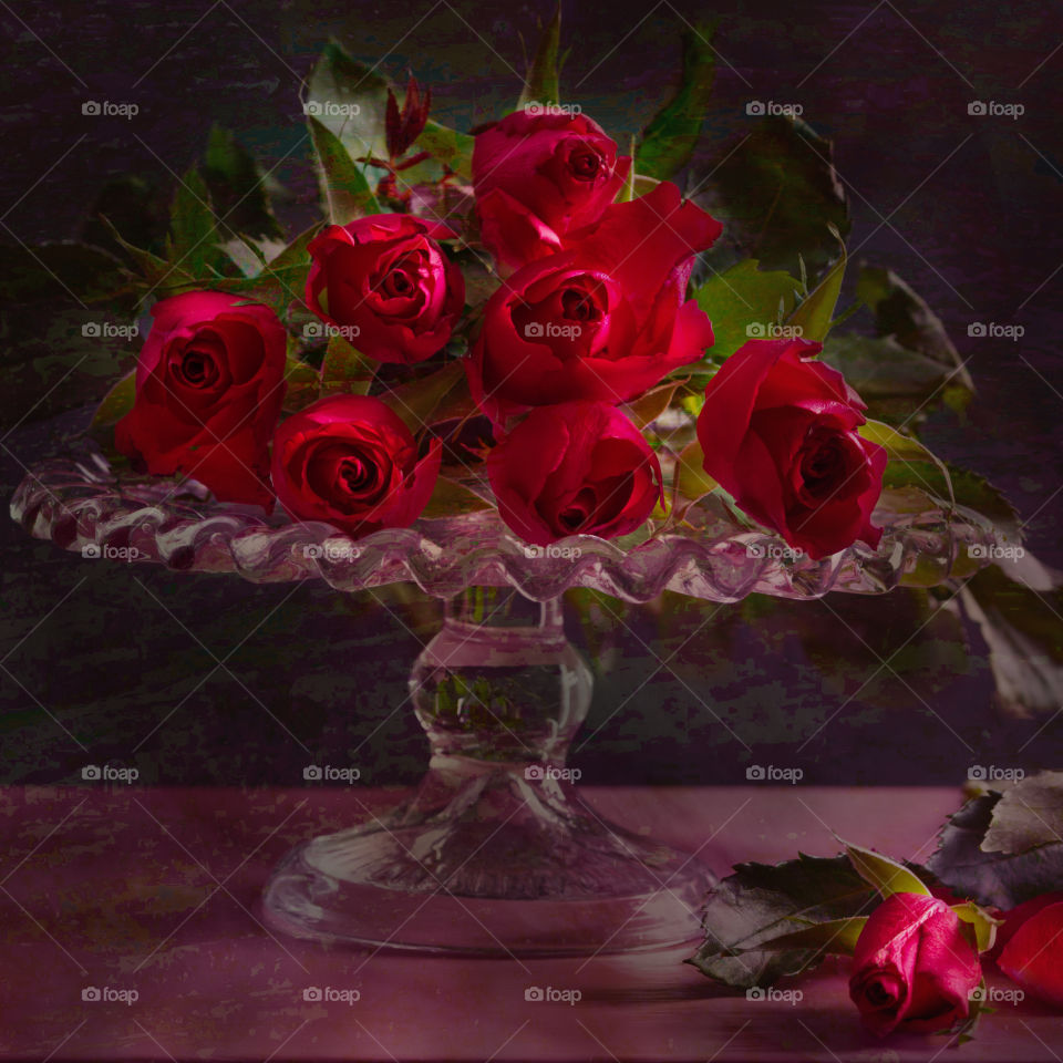 Beautiful red roses on a raised glass plate