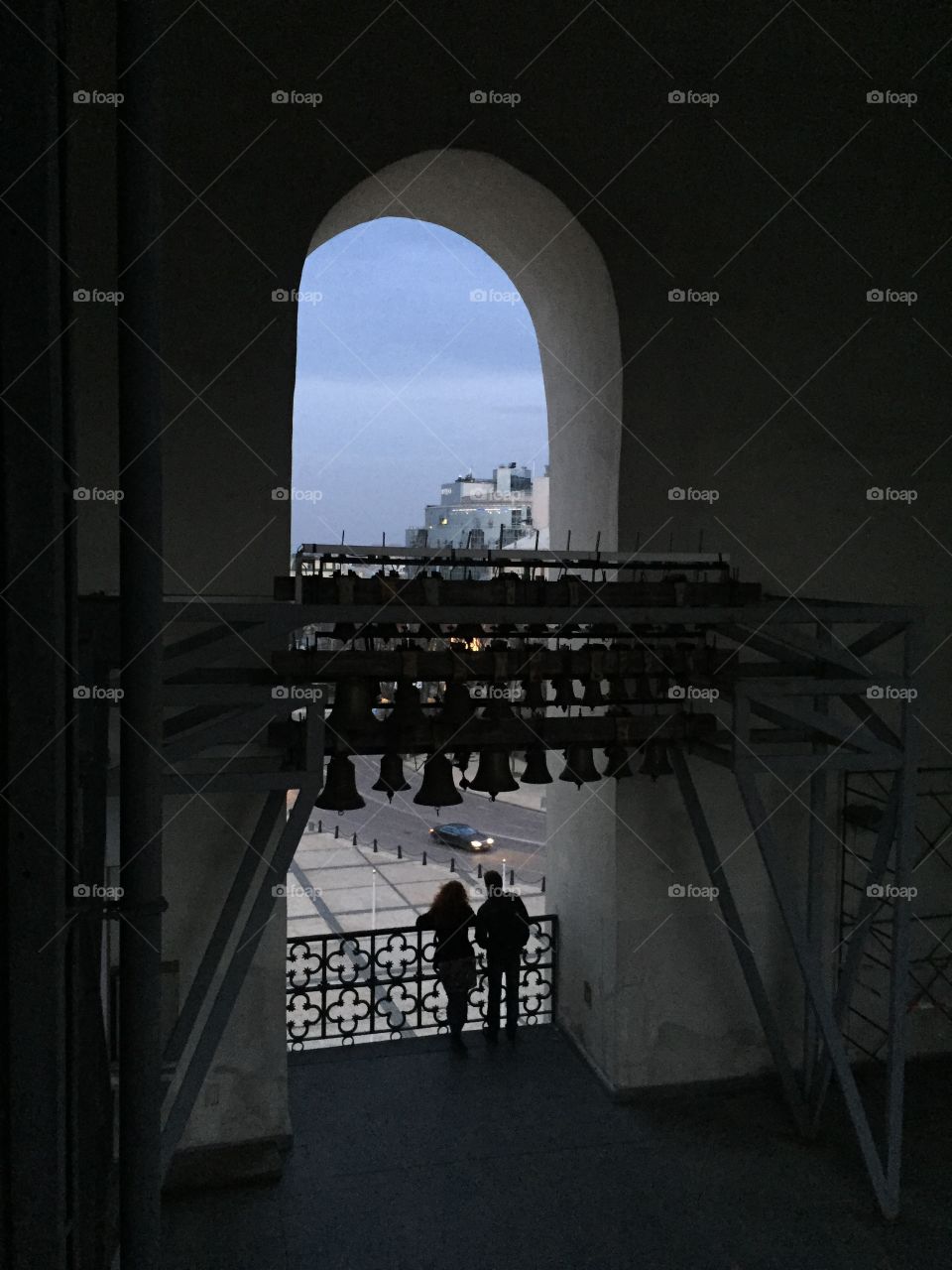 A couple standing on the viewing terrace of Sofia Kyivska bell tower