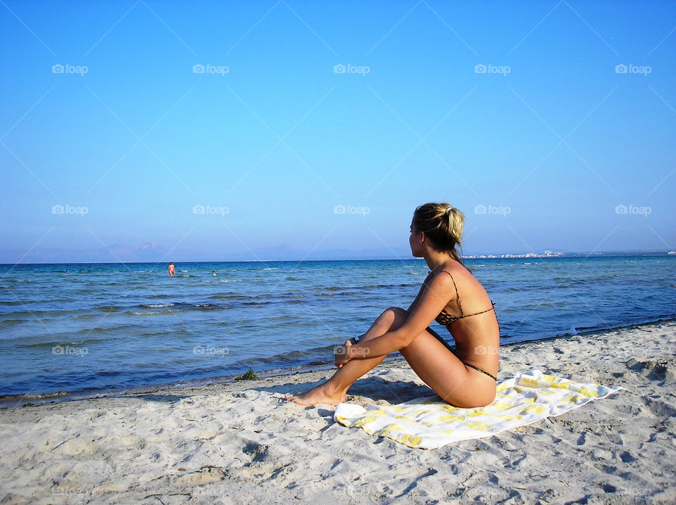 A girl in bikini on the beach in Alcudia, Mallorca