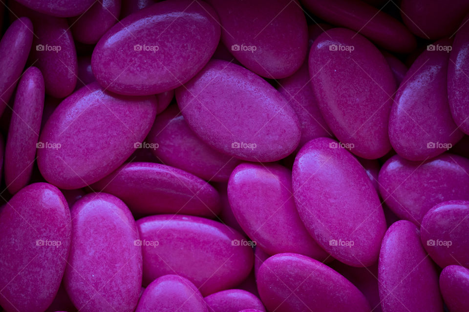 A portrait of a Belgian Babtism sugar called suikerbonen, rougly translated they are called sugar beans. they are filled with soft chocolate in a crispy sugar shell, a bit like m&m´s. they are given to people who visit a newborn baby.