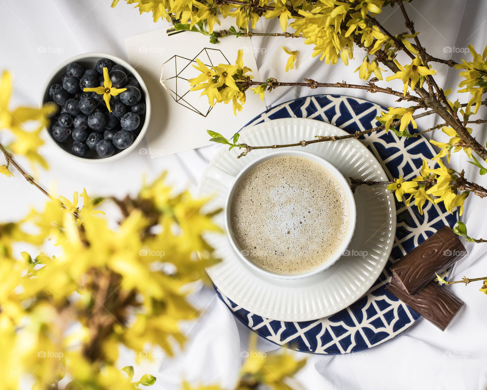 Spring coffee time with chocolate and blueberries 
