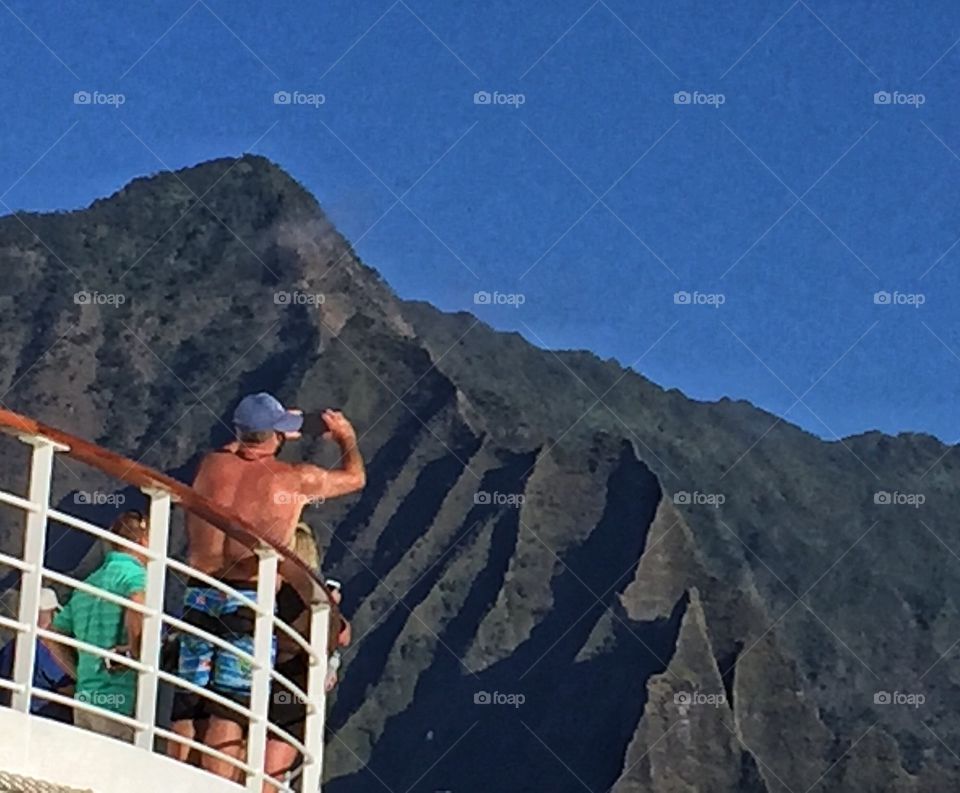 Tourist photographing Na Pali Coast