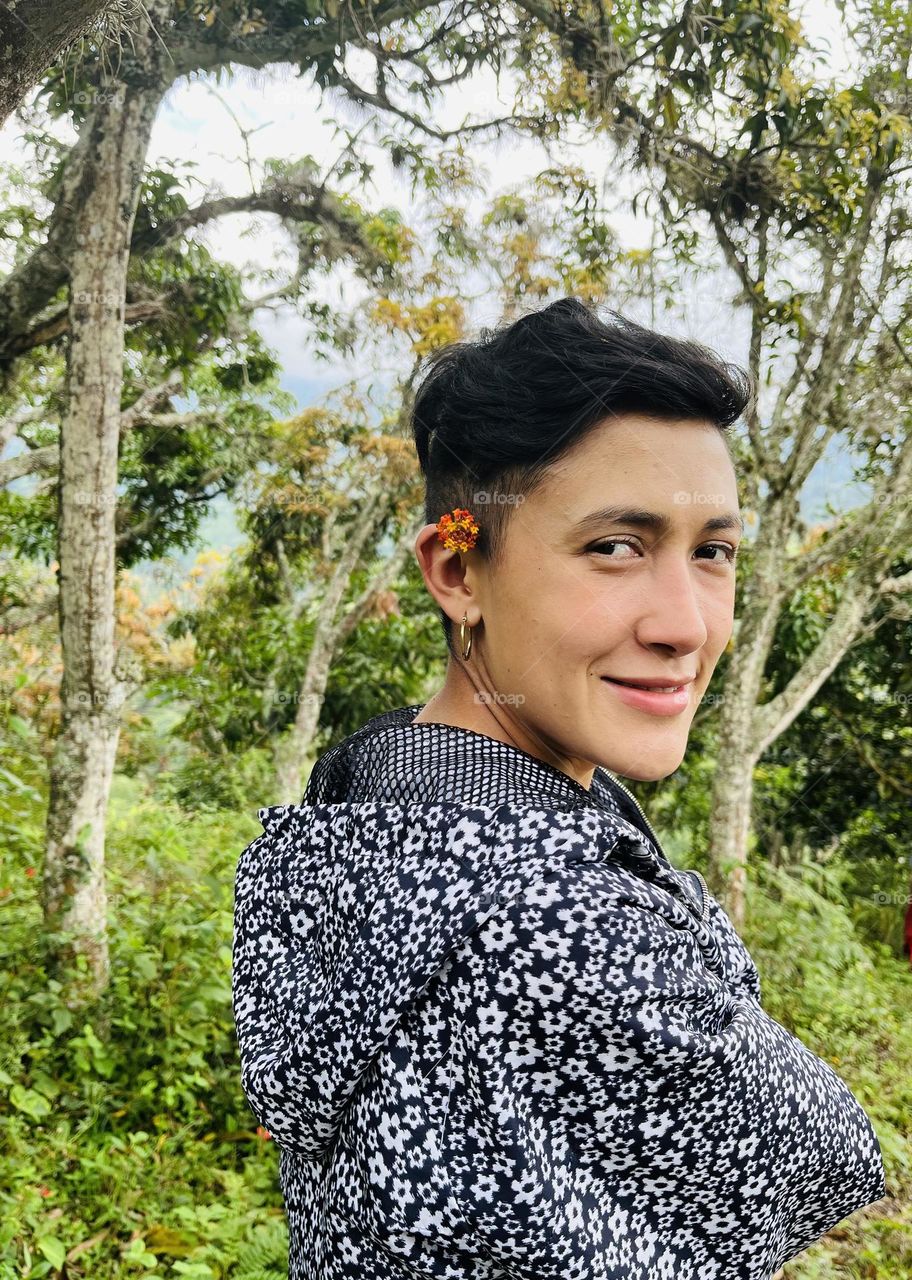 A strong woman smiling in the forest 