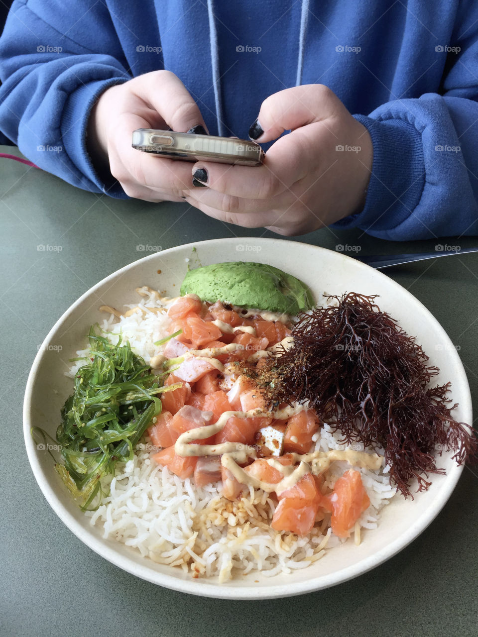 A person using cellphone at the restaurant 