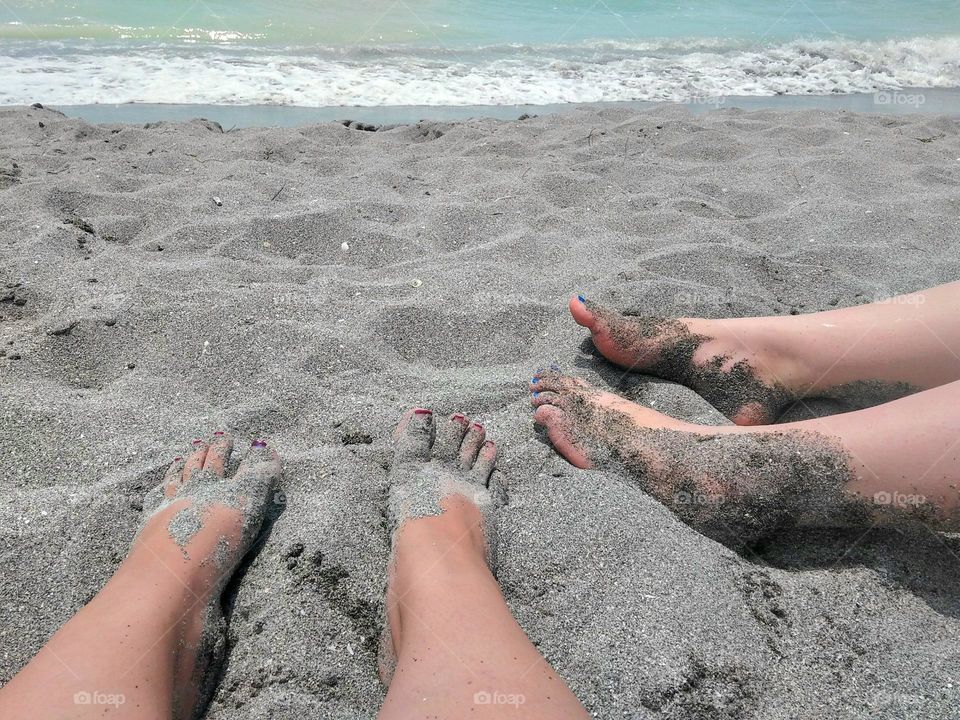 Enjoying a beautiful hot sunny summer day at the beach with our feet in the sand soaking up the sun off the Gulf Coast of Florida.