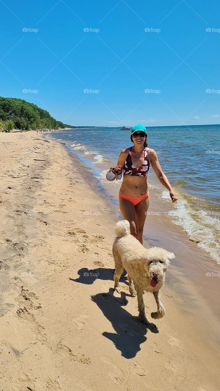 walking the dog on a secluded beach