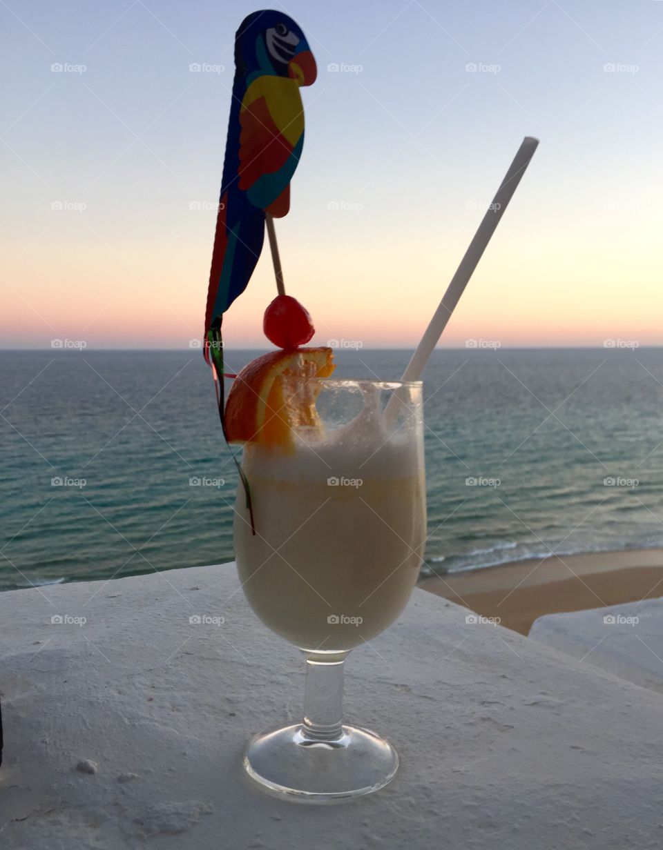 Pinacolada cocktail on holiday in front of the sea