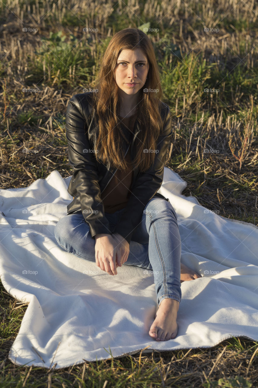 Young woman sitting in field