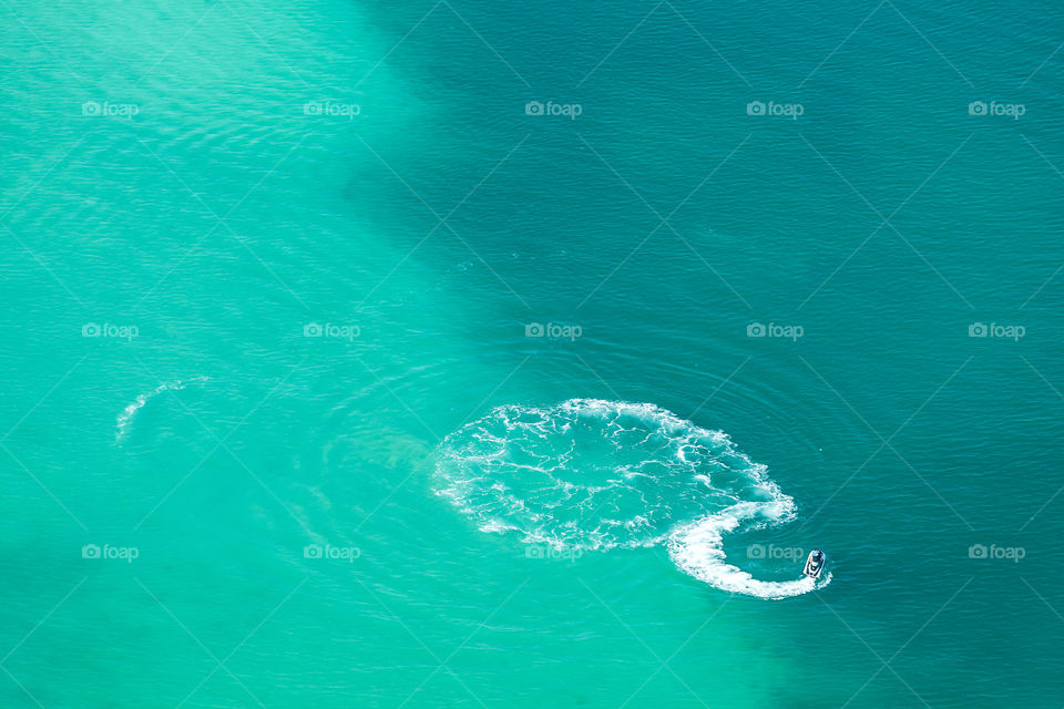 Turquoise seascape with jet ski, aerial view