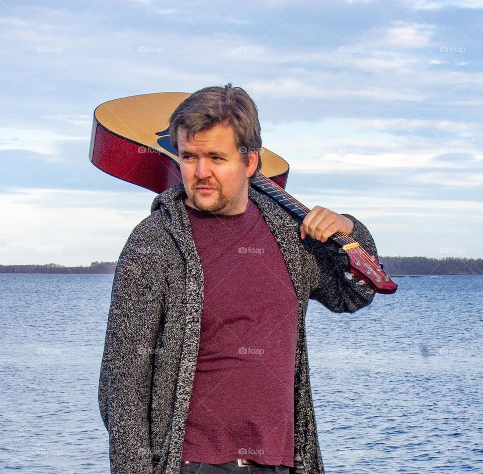 A walk by the sea. With a guitar a fall day. Portrait of a man. ❤️🧡💛💚💙💜❤️🧡💛