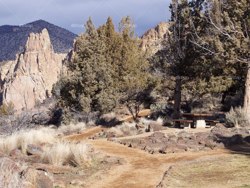 A nice dirt trail bordered with rocks goes through Smith Rock State Park in Central Oregon. 