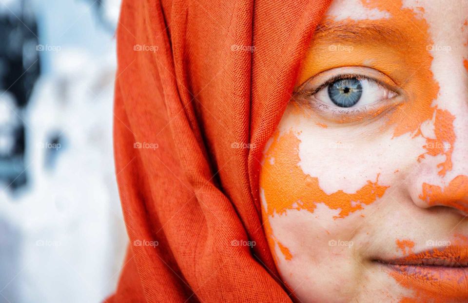 the girl with blue eyes and orange scarf