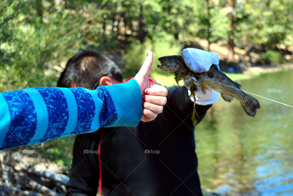 Thumbs up, fresh catch, fishing success